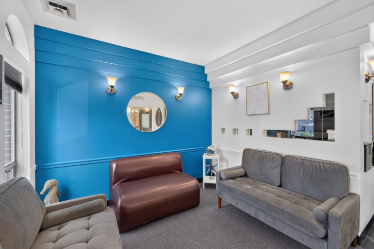 Modern consultation room with blue accent wall at Pacific Dental Center in Pacific, MO