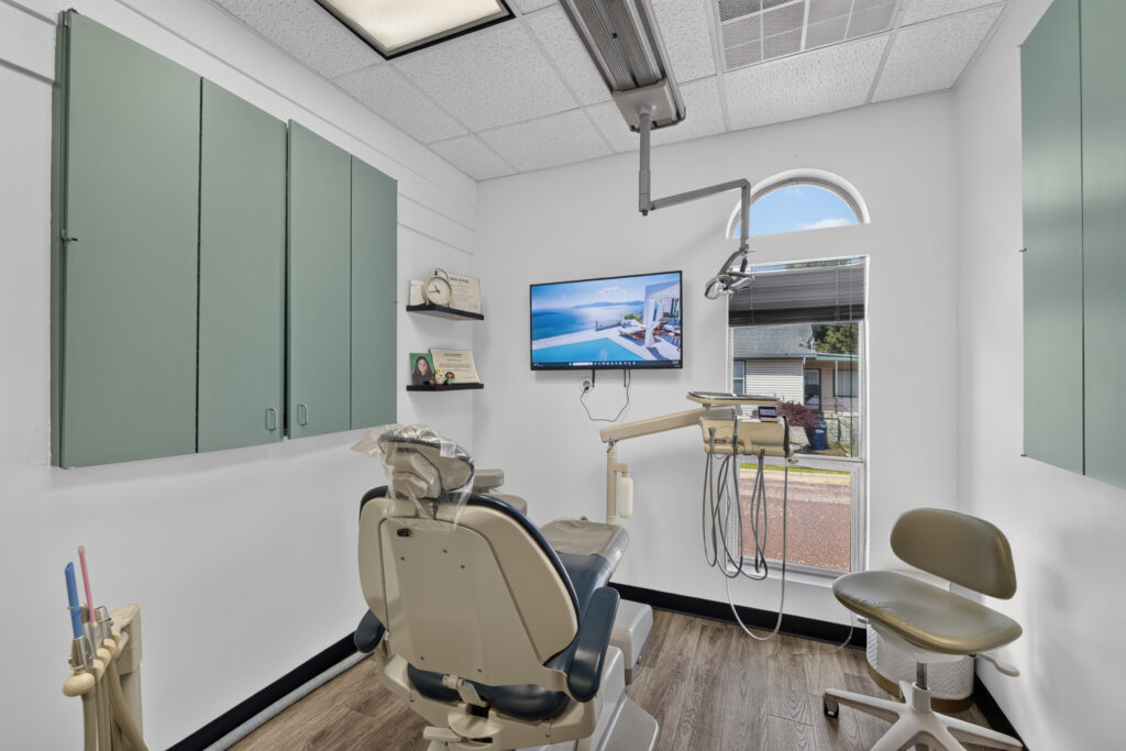 Bright dental operatory with treatment chair and digital technology at Pacific Dental Center